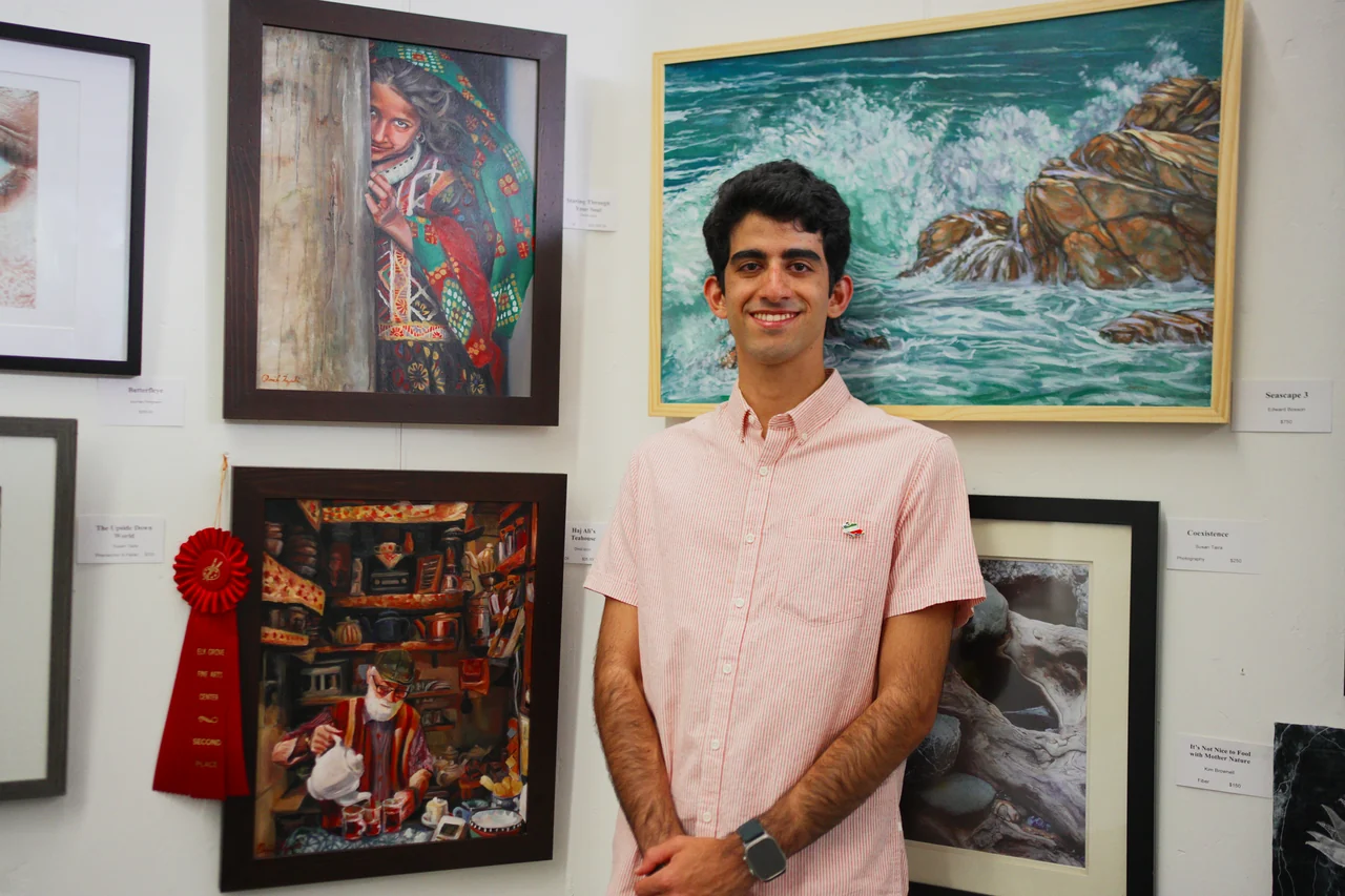 Omid Izadi with paintings at Elk Grove Fine Arts Center