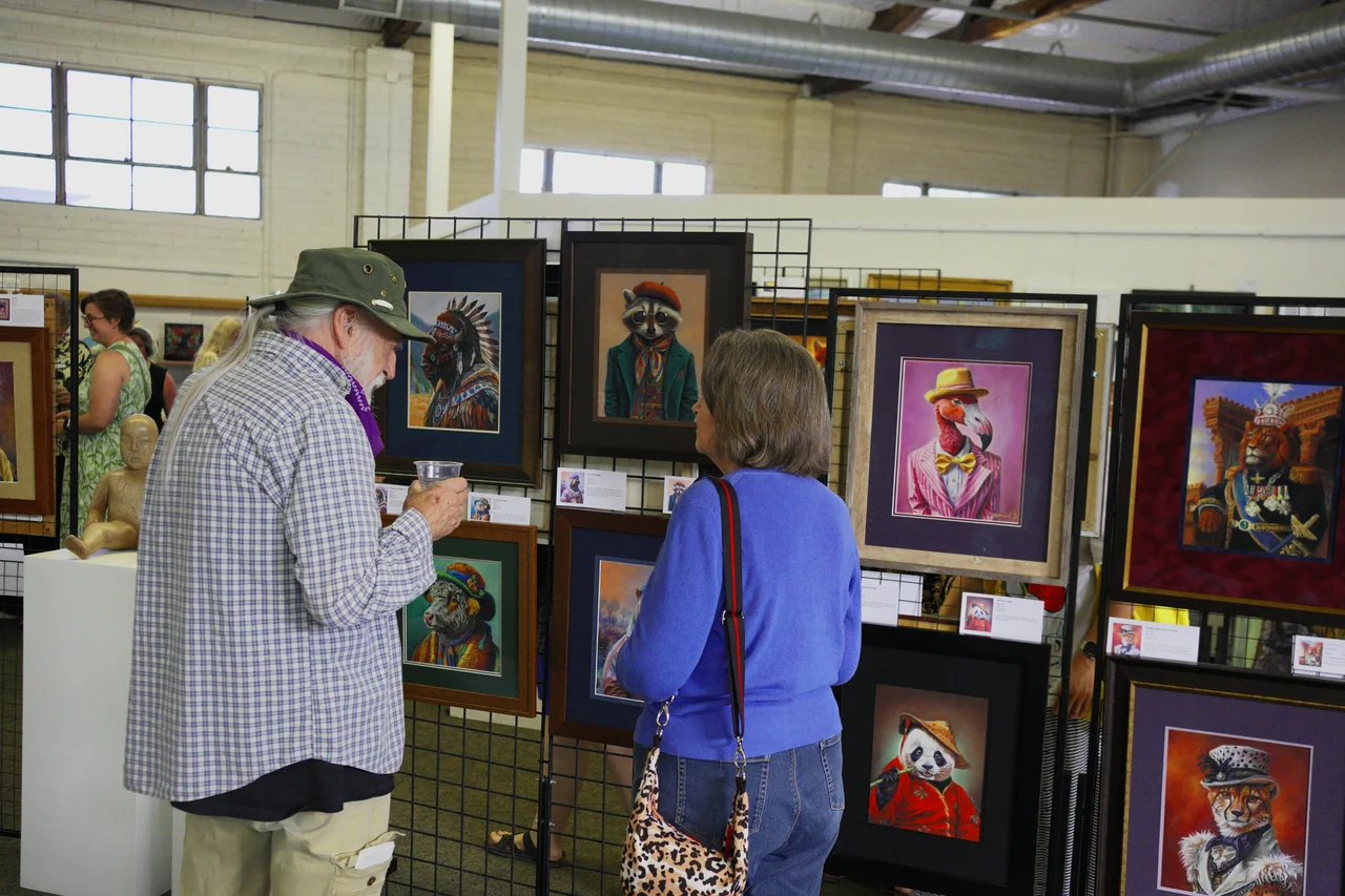 Visitors viewing paintings in the gallery